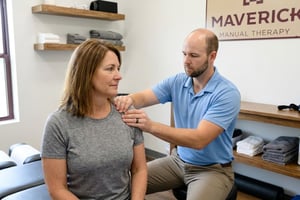 Athletic patient performing therapeutic exercise with a physical therapist at a manual therapy and sports rehabilitation clinic in San Antonio, TX