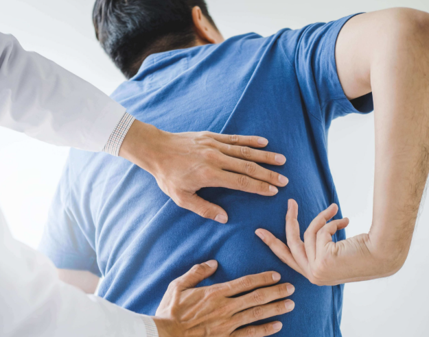 San Antonio physical therapist examining patient with lower back pain and sciatic nerve dysfunction